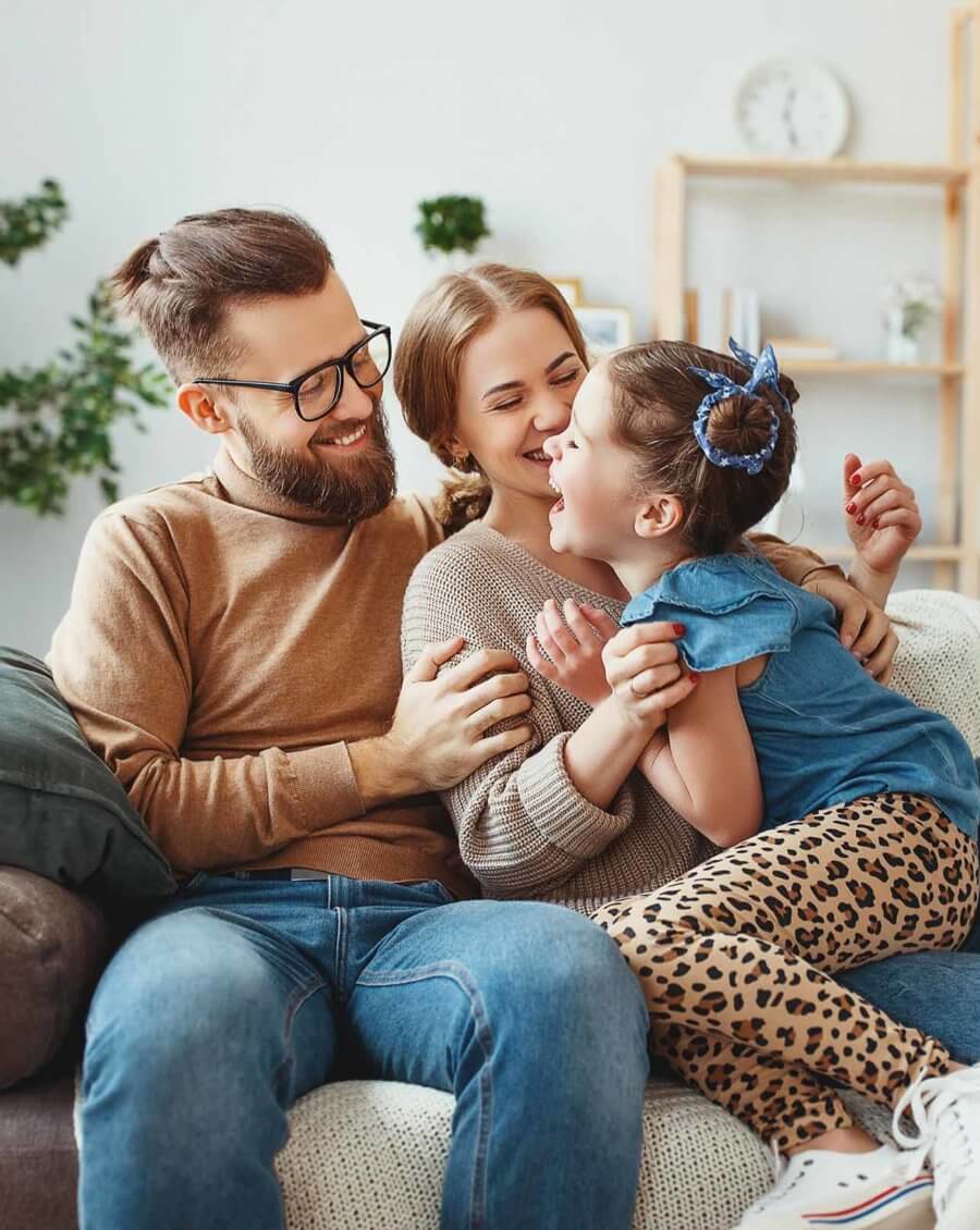 Happy family smiling and sitting on the couch