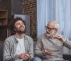 Young man and elderly man laughing