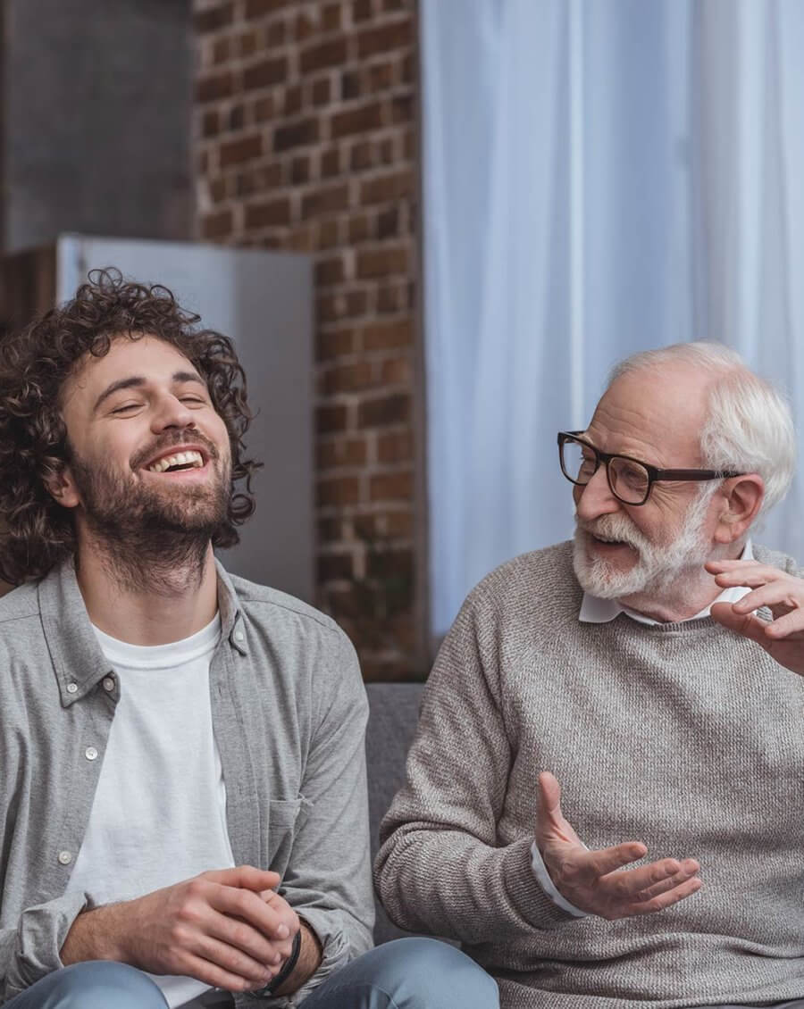 Young man and elderly man laughing