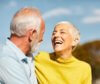 elderly couple laughing and enjoying their great teeth